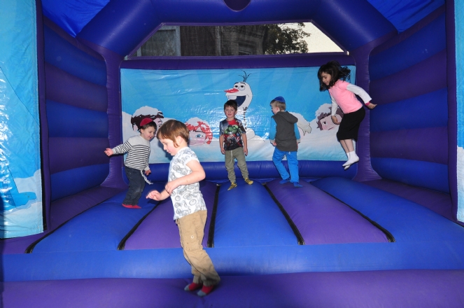 Children enjoying a jumping castle at a simchat Beis Hashoeva.JPG